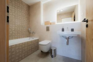 a bathroom with a toilet and a sink at Môj Hillside in Dolný Kubín