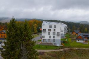a white house on a hill next to a street at Môj Hillside in Dolný Kubín