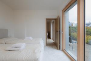 a bedroom with two beds and a sliding glass door at Môj Hillside in Dolný Kubín