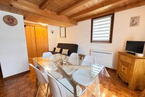 a dining room with a glass table and chairs at Alpine stay at the foot of the slopes in Crest-Voland