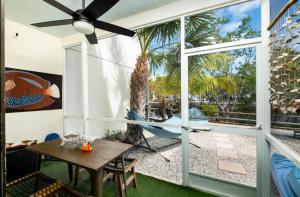 a patio with a table and a hammock on a porch at Saltwater Lagoon Front View, Marina, Kayaks in Key Largo