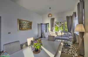 a living room with a couch and a table at Villa Scoglio with Private Hot Tub and Air Conditioning in Lierna