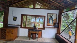 a room with a desk and windows in a house at Grace Backwater Villa Coorg in Suntikoppa