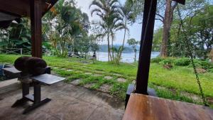 a view of the water from the inside of a house at Grace Backwater Villa Coorg in Suntikoppa