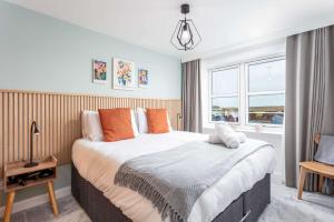 a bedroom with a large bed and a window at Old Prestwick Point - Donnini Apartments in Prestwick