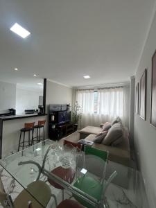 a living room with a couch and a glass table at Apartamento grande em Santa Teresa-ES in Santa Teresa +26 photos