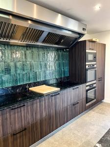 a kitchen with wooden cabinets and a counter top at DOMAINE De PLAISANCE in Cachen +30 photos