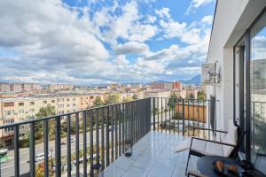 a balcony with a view of a city at Nest & Rest Apartment Fast Wi-Fi Free Parking in Braşov