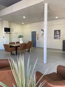 a dining room with a table and chairs at 63 Lodging Villa in Rustenburg