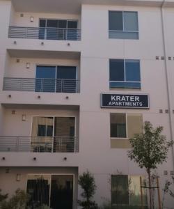a white building with a sign that reads kater apartments at Krater apartments in Accra