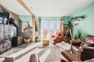 a living room with a couch and a fireplace at Beachside in Ferryside