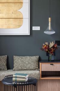 a living room with a couch and a table at 1.75 Paris La Source in Paris