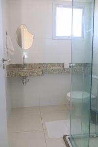 a bathroom with a shower and a sink and a toilet at Apartamento Vista Mar atalaia varanda gourmet in Aracaju