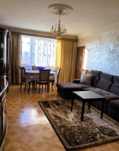 a living room with a couch and a table at Sunrise Apartment Gai Avenue One, Yerevan in Yerevan