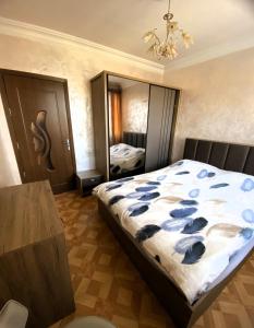 a bedroom with a bed and a large mirror at Sunrise Apartment Gai Avenue One, Yerevan in Yerevan +14 photos