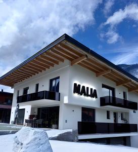 a building with the mala sign on it at MALIA - Alpine Hideaway in Pertisau