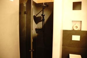 a shower in a bathroom with a black shower stall at MALIA - Alpine Hideaway in Pertisau