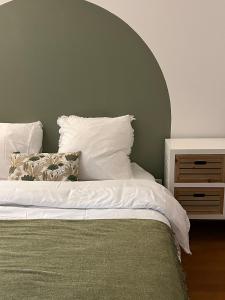 a bed with white sheets and pillows in a bedroom at Résidence Les Oliviers, La Défense 20 mn, 4 to 6 people in Bezons