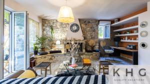 a living room with a stone wall at Anti-Pera Cottage with private pool in Dilinata village! in Argostoli