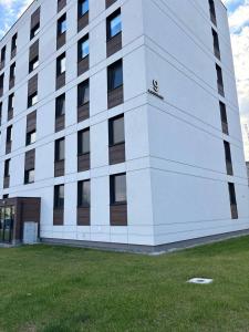 a large white building with windows on the side of it at Studio Leszczyńskiego Przemyśl in Przemyśl