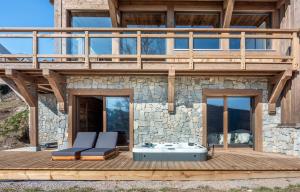 a house with a deck with a hot tub at Chalet de Scott, luxe avec spa et sauna in Gérardmer