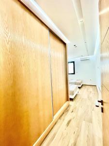 a room with a large wooden wall with a door at Maison Miralin Beach in Hammam Sousse