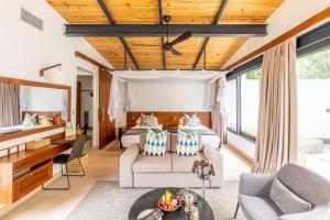 a bedroom with a bed and a living room at mp resort in Nyarugina