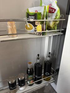 a refrigerator shelf with food and food items on it at Studio Leszczyńskiego Przemyśl in Przemyśl