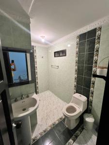 a bathroom with a toilet and a sink at Cabaña Ivan in Santa Marta