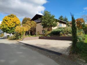 a house with a driveway in front of it at Haus am Aartalsee in Bischoffen