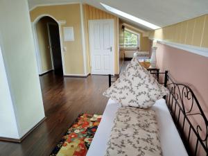 a couch with pillows on it in a living room at Haus am Aartalsee in Bischoffen