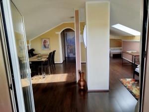 a living room and dining room with a dining table at Haus am Aartalsee in Bischoffen