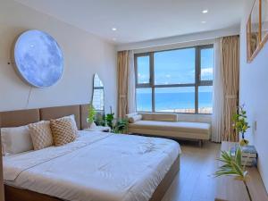 a bedroom with a large bed and a large window at The Song Boutique Apartment in Vung Tau +107 photos