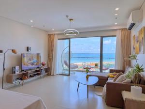 a living room with a view of the ocean at The Song Boutique Apartment in Vung Tau