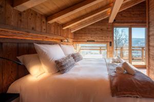 a bedroom with a large bed in a log cabin at Chalet de Scott, luxe avec spa et sauna in Gérardmer
