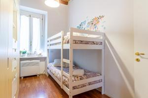 a bedroom with two bunk beds in a room at Suite Manzoni by Houset in Monza