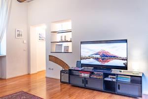 a living room with a large flat screen tv at Suite Manzoni by Houset in Monza