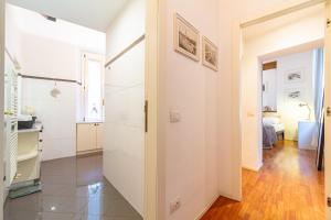 a hallway with white walls and wood floors in a room at Suite Manzoni by Houset in Monza +18 photos