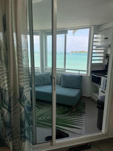 a living room with a view of the ocean at Guadeloupe Ilet Gosier best view in Le Gosier