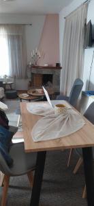 a living room with a wooden table with chairs at Αρσινόη apartments 4 in Arachova
