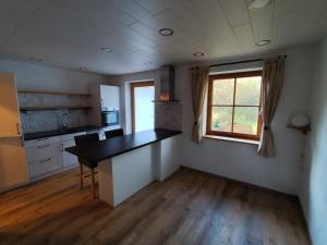 an empty kitchen with a table and a window at FeWo Pfaffenhofen-Ortsteil Blick ins Grüne in Pfaffenhofen an der Ilm +5 photos