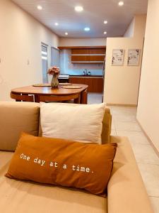 a couch with a pillow that says one day at a time at Shiny in Clorinda +3 photos