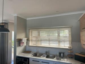 a kitchen with a sink and a window at 20 At Jeanette in Ludwigsdorf