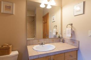 a bathroom with a sink and a mirror at River Scene 30 Night Minimum in White Salmon +14 photos