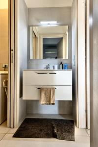 ein Badezimmer mit Waschbecken und Spiegel in der Unterkunft lakefront and parking - Lakefront Escape in Desenzano del Garda + 7 Fotos