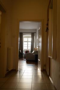 a hallway with a living room with a couch at Residence Fink Central Apartments in Bolzano