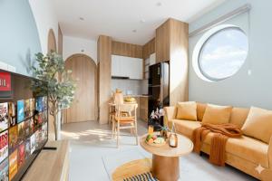 a living room with a couch and a table at Label6 To Ngoc Van - Crescendo Boutique Studio in Hanoi