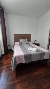 a bedroom with a bed and a wooden floor at Large apartment close to everything! North area in Cochabamba