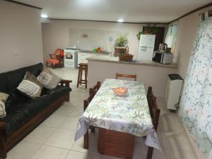 a living room with a table and a couch at Depto 4 in Sierra de la Ventana