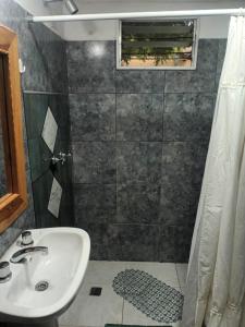 a bathroom with a sink and a shower at Doña clotilde in Sierra de la Ventana